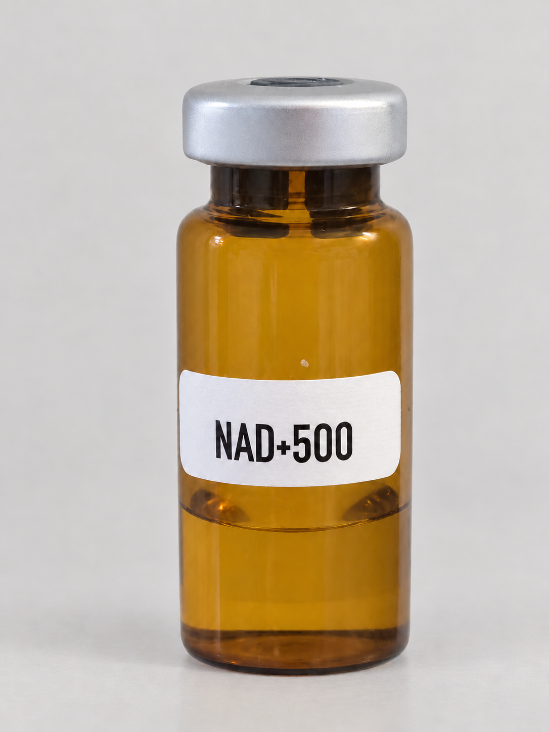 Lightly retouched user-supplied photo of an amber NAD+500 vial with gray cap; label reads NAD+500.