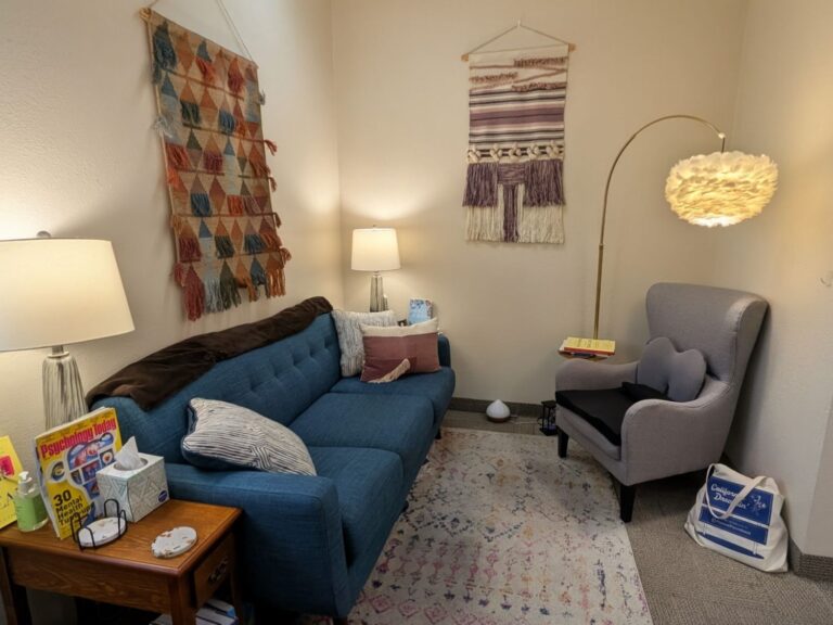 Dakota Westlake’s Redlands counseling office with a blue sofa and armchair